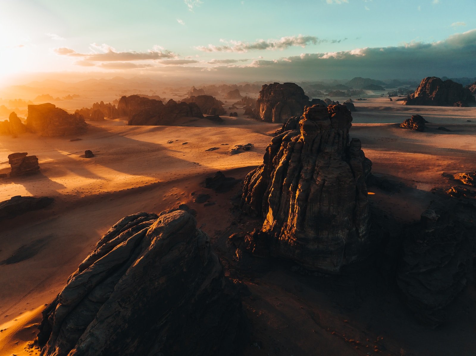 an aerial view of a desert with rocks and sand